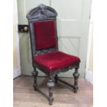 Mid Victorian oak side chair, the framework with heavily carved detail, facial mask, geometric