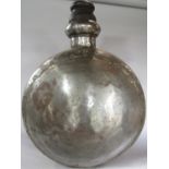 A large metal riveted Indian water bottle, of circular form with a wooden stopper. 60cm diam