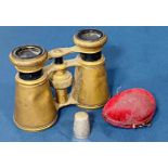 A pair of opera glasses and a hallmarked silver thimble in an egg shaped case