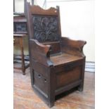 A 17th century and later enclosed wainscot chair, with box base with panelled framework and rising