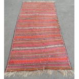A large flat weave kilim, with multi coloured lines of pattern, 315cm x 150cm.