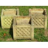 A set of three weathered buff coloured cast composition stone square cut garden planters with