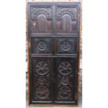 An antique oak door in the old English style enclosing six carved arcaded and flower head panels,