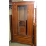 A suite of Edwardian American walnut bedroom furniture comprising single wardrobe enclosed by a