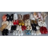 A collection of dolls clothes and shoes including hand made sewn and knitted garments, baby socks