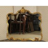 A decorative gilt framed wall mirror with repeating shaped and leaf moulded frame, 72 x 75 cm