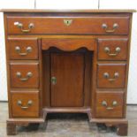 19th century mahogany kneehole writing desk, the central kneehole cupboard surrounded by an