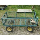 A useful four wheeled hand cart with green painted light steel framed body with drop sides and