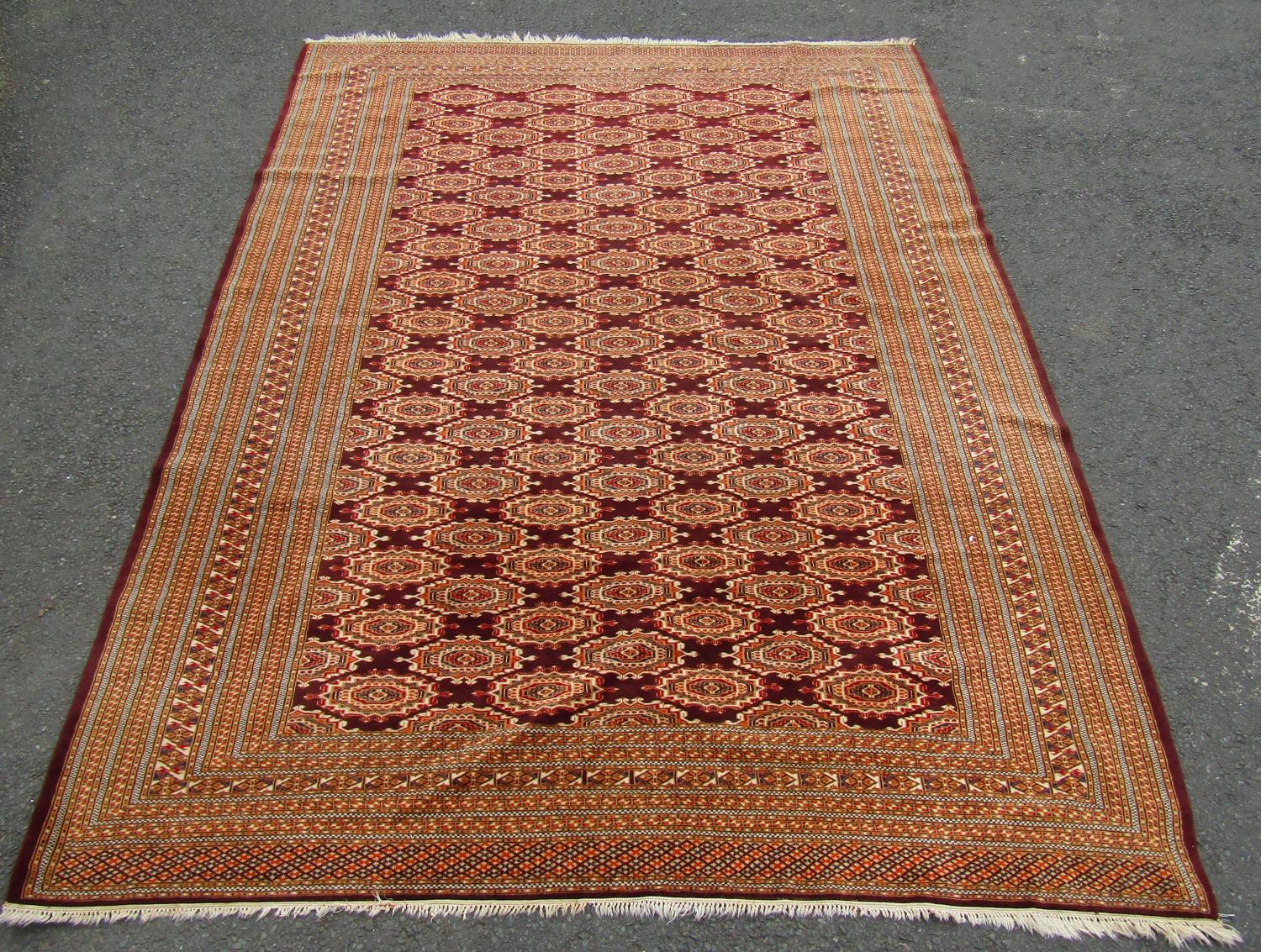 A large Turkoman carpet with a field of brown interspersed with many elephant foot guls, 310cm x