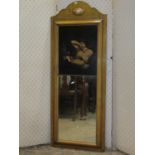 A pier glass, the timber frame enclosing a rectangular mirror plate, the printed panel showing