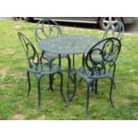 A contemporary green painted cast aluminium five piece garden terrace set comprising circular topped