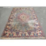 A large country house Middle Eastern carpet with large floral palmettes on a pale blue ground, 351cm