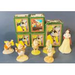 A collection of boxed Royal Doulton Snow White and Dwarfs set including Snow White, Bashful, Grumpy,