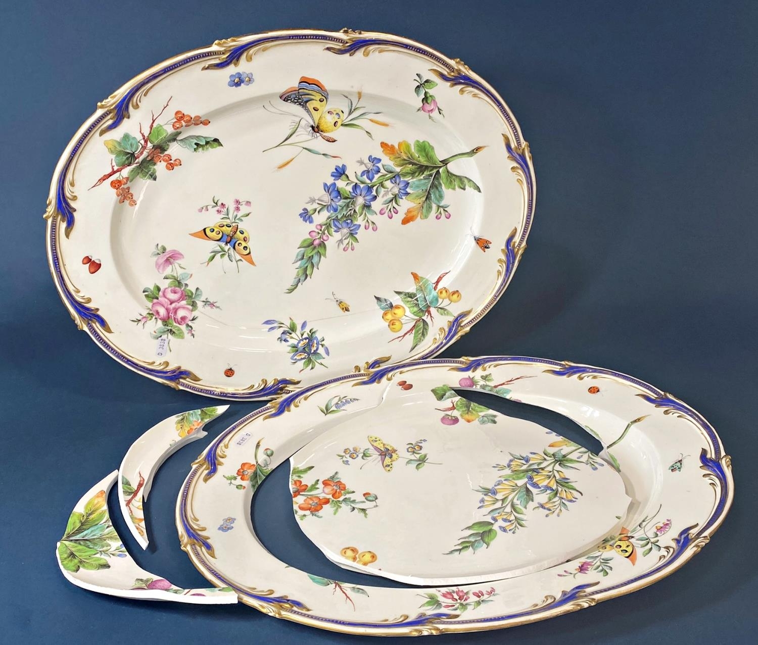 A pair of large 19th century hand painted platters with painted sprays of butterflies,