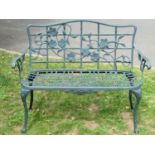A contemporary green painted cast aluminium two seat garden bench with decorative pierced trailing