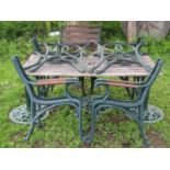 A suite of garden furniture with matt green painted finish and open simple scroll pattern design,