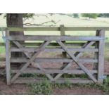 Two matching weathered softwood five bar paddock gates with galvanised fittings and chamfered