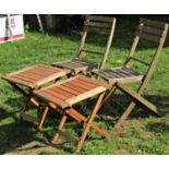 A pair of weathered hardwood folding garden chairs with slatted seats and backs together with a pair