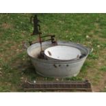 A vintage oval two handled galvanised steel bath together with a smaller enamel example (both