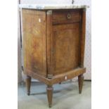 A burr and figured walnut veneered bedside cabinet with serpentine front enclosed by a single door