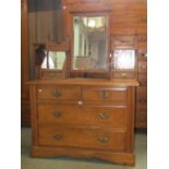 An Edwardian walnut and figured walnut veneered dressing chest of two long and two short drawers