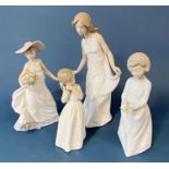 Four Lladro figures complete with packaging, all female characters, either holding bouquets or in