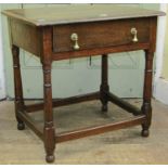 An Old English oak side table on four gun barrel supports, enclosing a single frieze drawer, 70cm