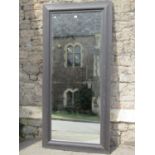 A dressing mirror in a moulded ebonised frame 176 x 82 cm