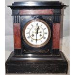 A substantial Victorian black slate and marble mantle clock with enamel dial and visible escapement,