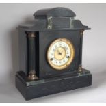 Victorian black slate and marble mantle clock with column support and eight day striking movement