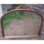A Victorian arched overmantle mirror with bevelled edge plate, carved and scrolled mount, 92 cm x