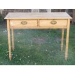 A 19th century stripped and waxed pine side table enclosing two frieze drawers with simulated bamboo