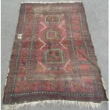 An old worn and faded Kazak rug, 180cm x 120cm.