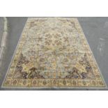 A large floral patterned carpet of Middle Eastern design with pale blue and green field, 350cm