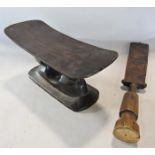 An antique African headrest with an incised geometric pattern and a central hole to the base, 31cm