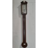 A Georgian walnut stick barometer with simple banded detail with silvered dial and engraved