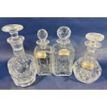 Four cut glass decanters of varying design , three with hallmarked silver drinks labels, sherry,
