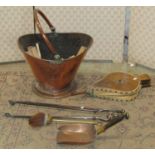 A 19th century copper helmet shaped coal scuttle with loose loop handle, small shovel, pair of