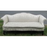 19th century camel back sofa with scrolled arms, the open framework with H shaped supports and