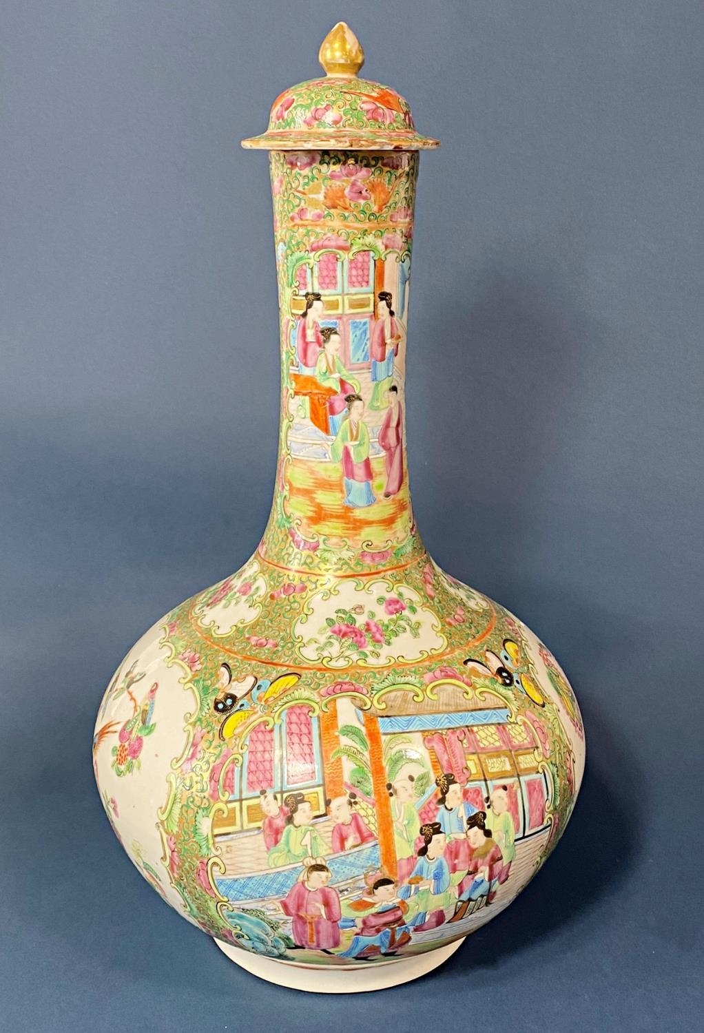 Chinese 19th Century Canton famille rose bottle vase with cover, depicting figures in a garden,