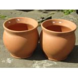 A pair of contemporary terracotta oviform garden planters 40 cm in diameter, approx same in height