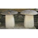 A pair of weathered cast composition stone staddle stones with domed caps, 45 cm high approximately