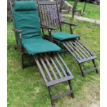 A pair of contemporary stained and weathered folding hardwood garden steamer type chairs with