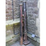 A pair of 19th century cast iron fluted cylindrical gate posts with domed caps (af), one raised on a