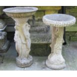 A weathered composition stone two sectional bird bath, the pedestal in the form of a naturalistic