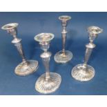 Four Georgian style silver plated column candlesticks with fluted flared bases and removable