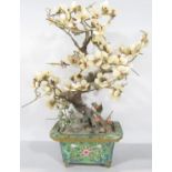 A Chinese hard stone and glass blossom tree set in a cloisonné planter.