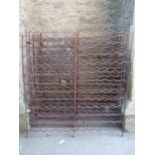 Four matching vintage weathered ironwork folding wine racks, each to hold 120 bottles, 114 cm wide x
