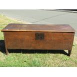 An 18th century elm six plank coffer, with steel lock plate dated 1763, monogrammed I.B.? 115cm wide