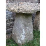 A good weathered natural stone staddlestone of square tapered form beneath a domed cap, 60cm